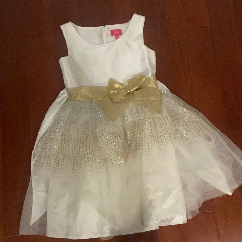 A white dress with a gold bow